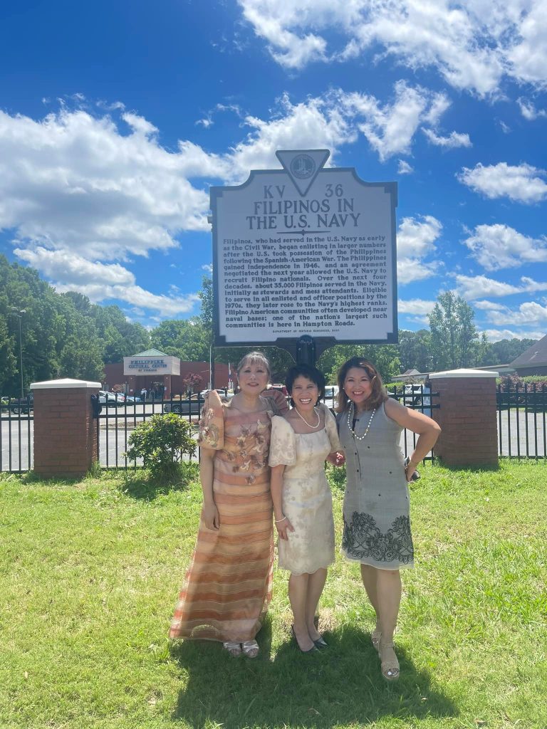 Arlene, Cynthia, and Justine stand underneath the plaque dedicated to the Filipinos in the Navy from the state of Virginia.  